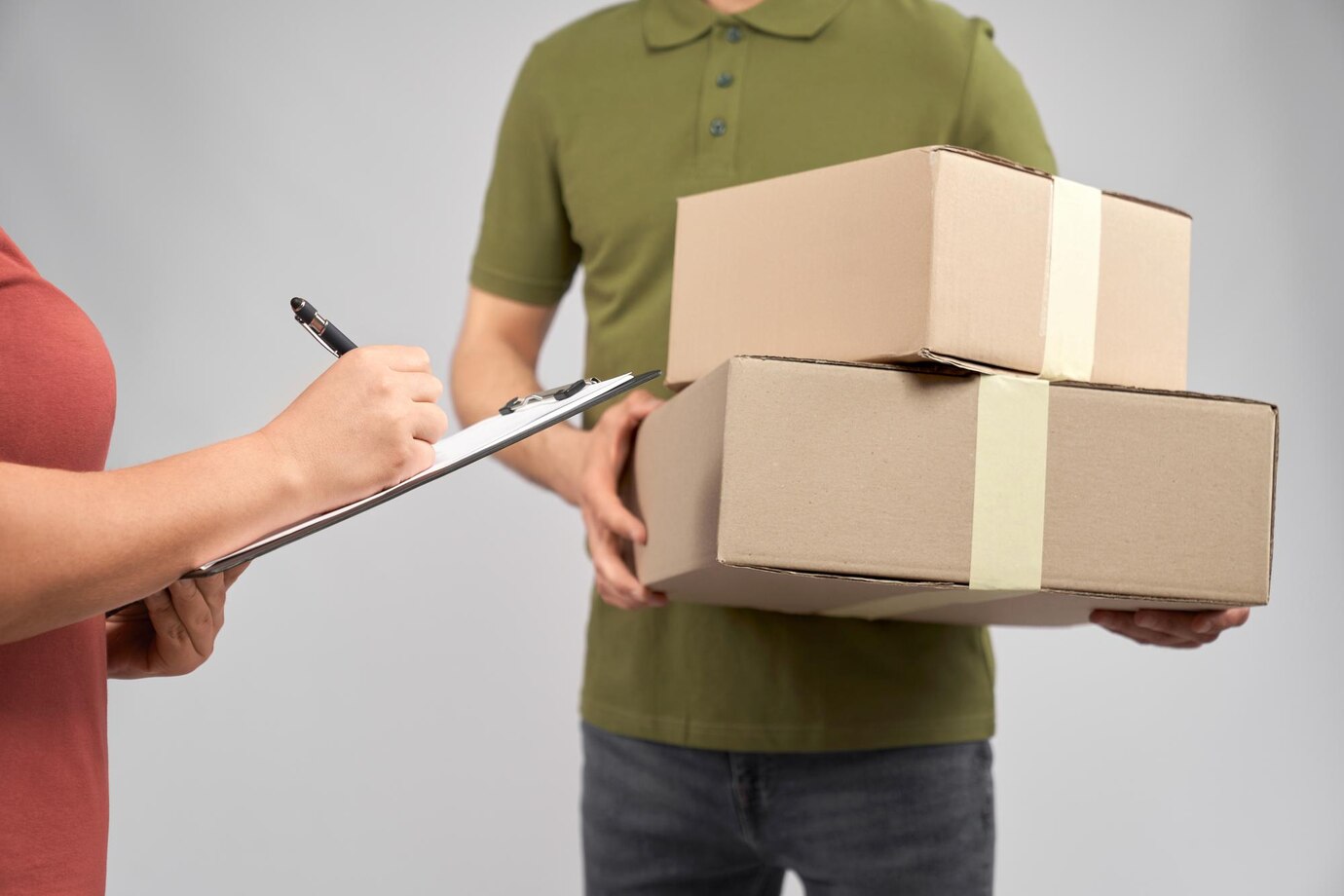 delivery-man-holding-two-boxes-client-signing-receipt_651396-982